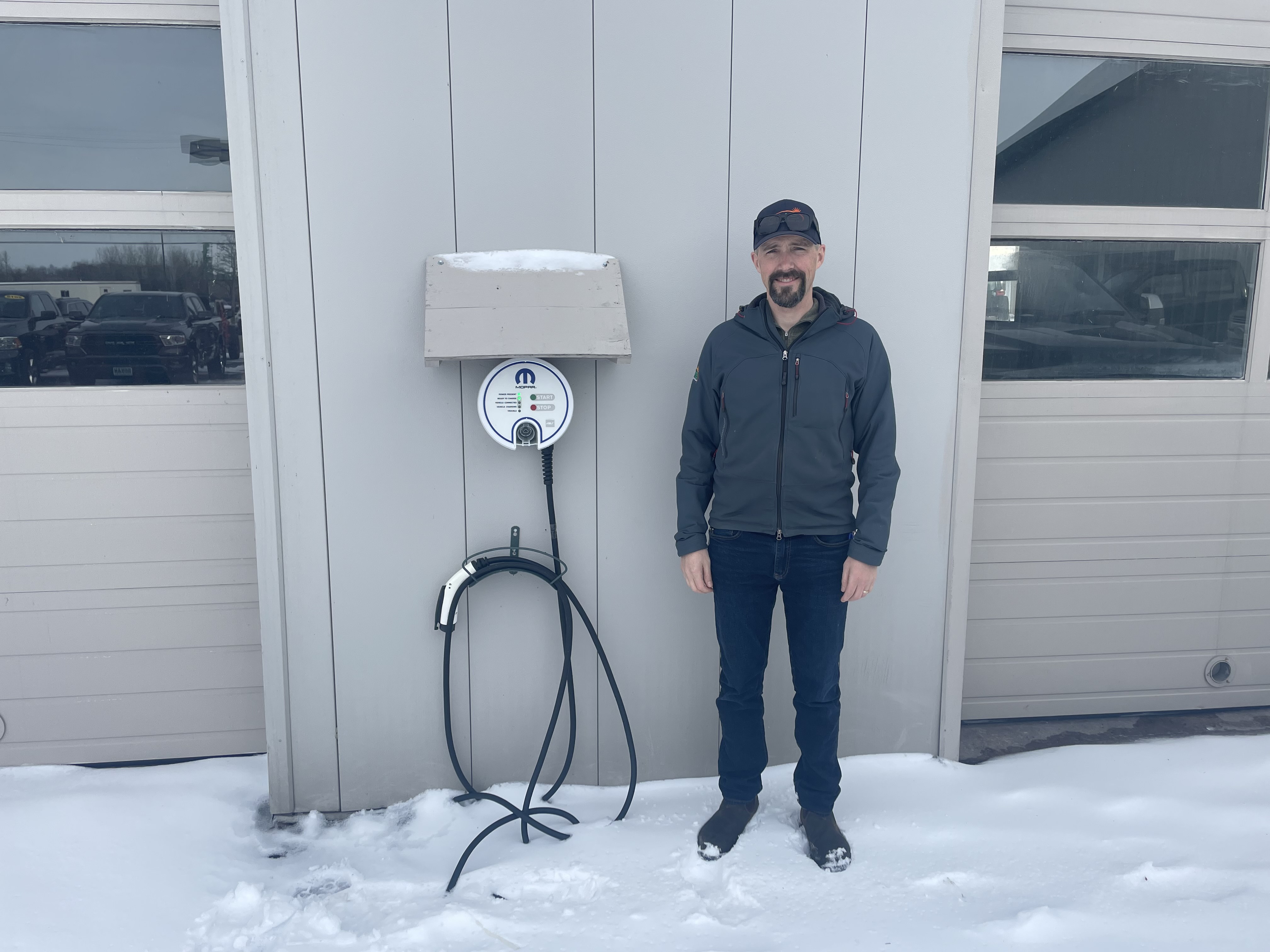 Green Mountain Solar president with EV charger